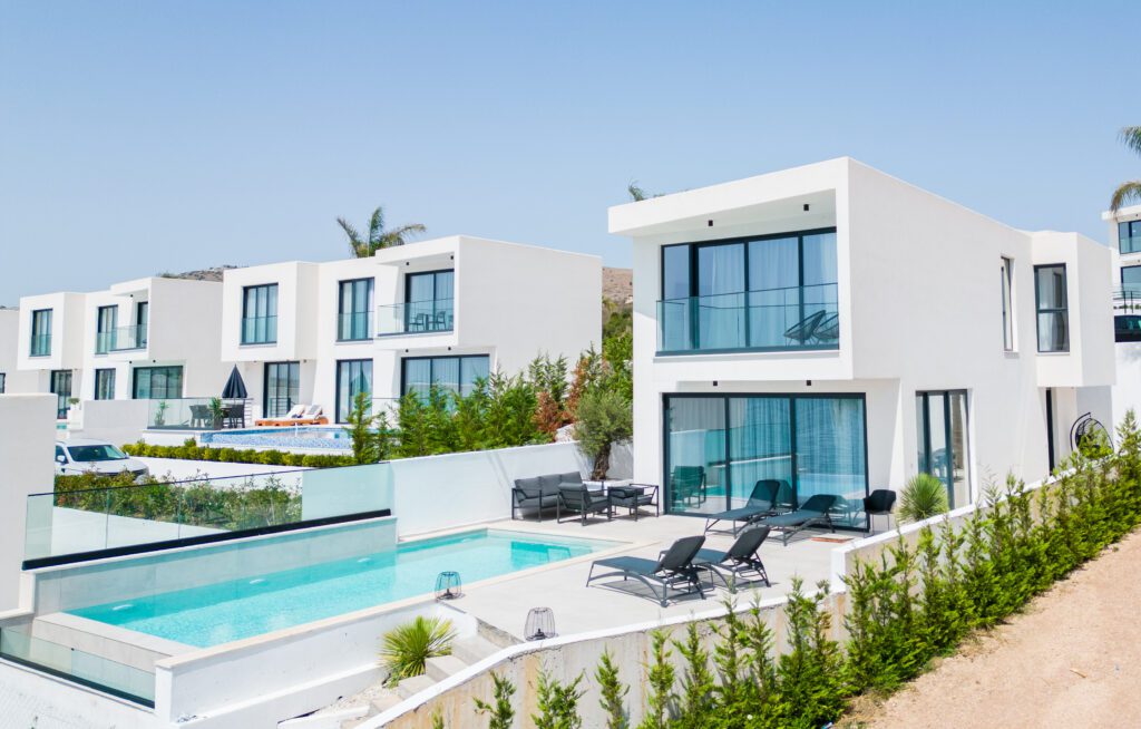 Palmera Resort Albania, Villa with pool amidst lush palms, neighboring white Mykonian-designed villas.
