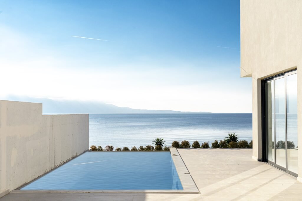 Swimming pool view from a villa highlighting the Ionian Sea and Corfu views, presented by real estate Saranda, Albania