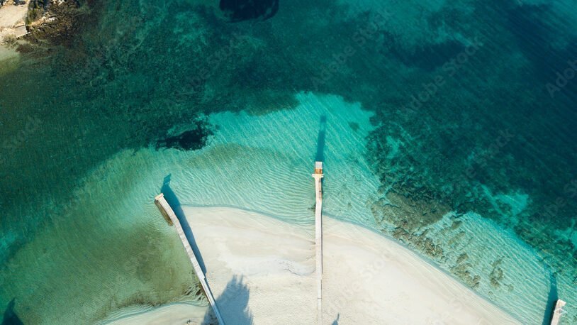 Drone view of Ksamil showcasing its three islands, sandy shores, and crystal-clear waters