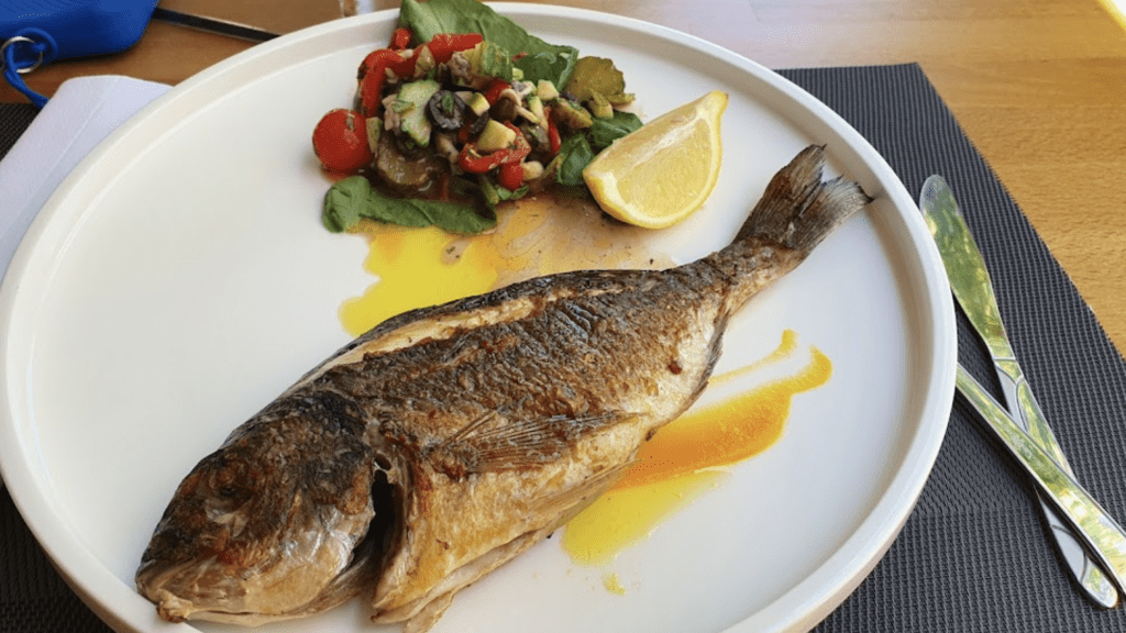 fish in plate in a restaurant called black marlin in saranda, albania