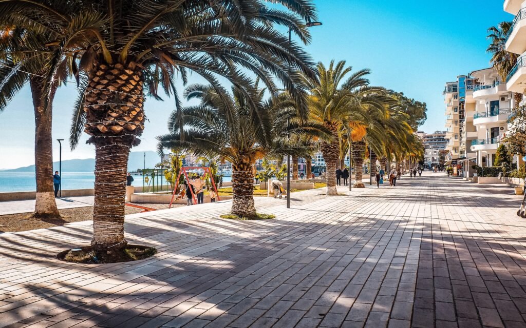 saranda promenade with palms and beaches with people walking in the morning with sea views of the city