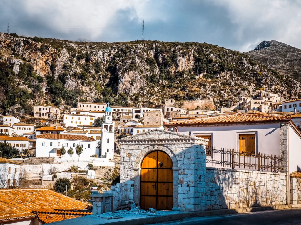 Dhermi, Architectural cliff-top homes nestled in the mountains, skillfully crafted from rocks with distinct roofing