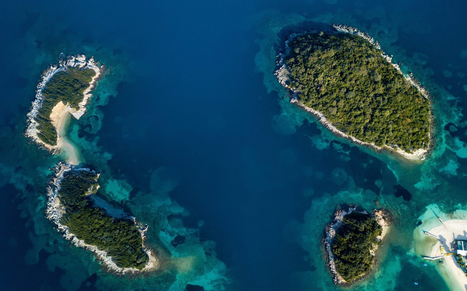 albania or corfu Aerial view of Ksamil Islands showing the blue ionian sea along with the white shore and green islands